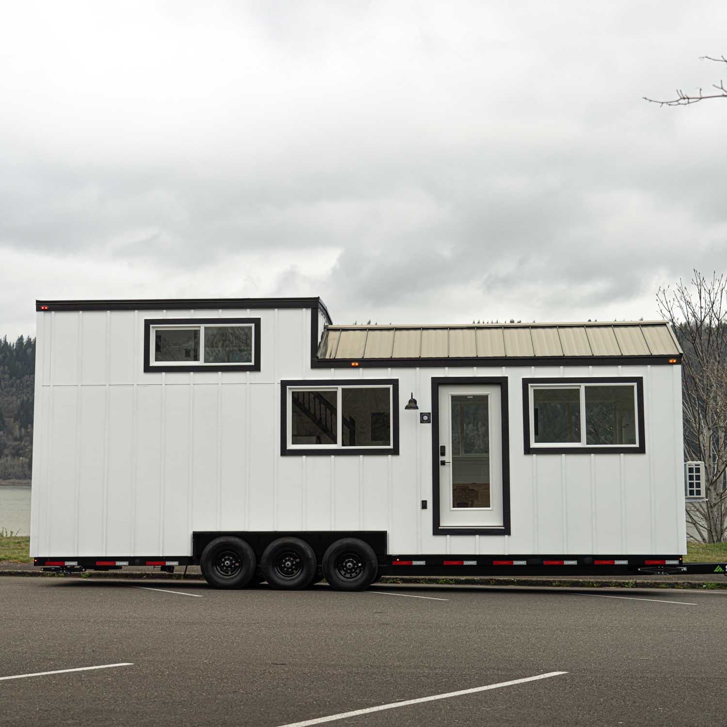 Outside view of a white farmhouse Heritage tiny home