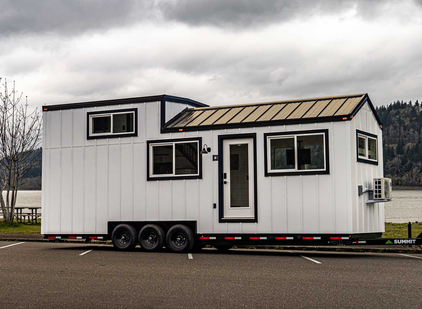 Exterior of a Heritage tiny home with cloudy sky. This tiny home is for sale as part of the Signature Series