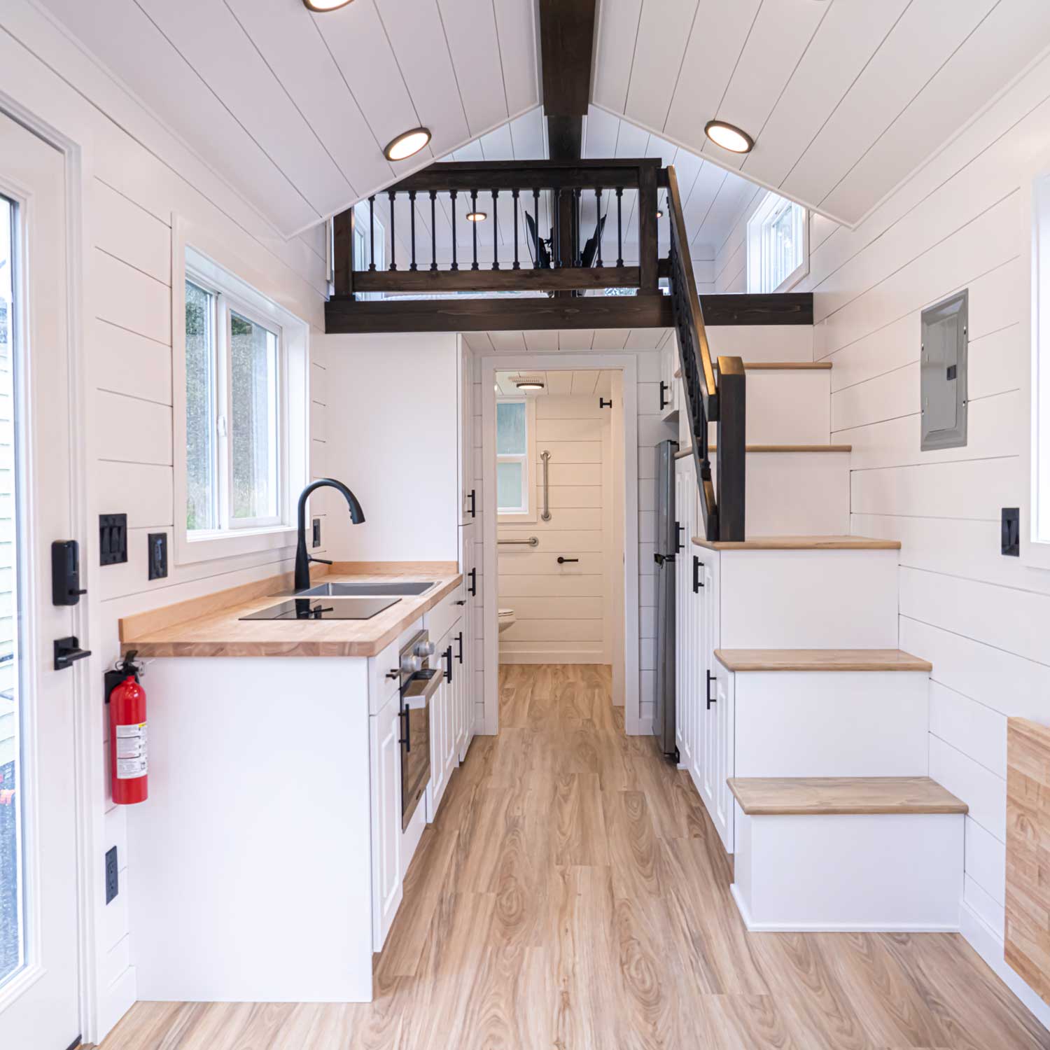 Heritage farmhouse interior with kitchen, and stairs to the loft