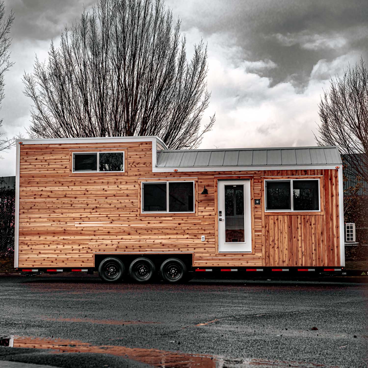 Modern style Heritage tiny home outside view with cloudy sky and trees in the background