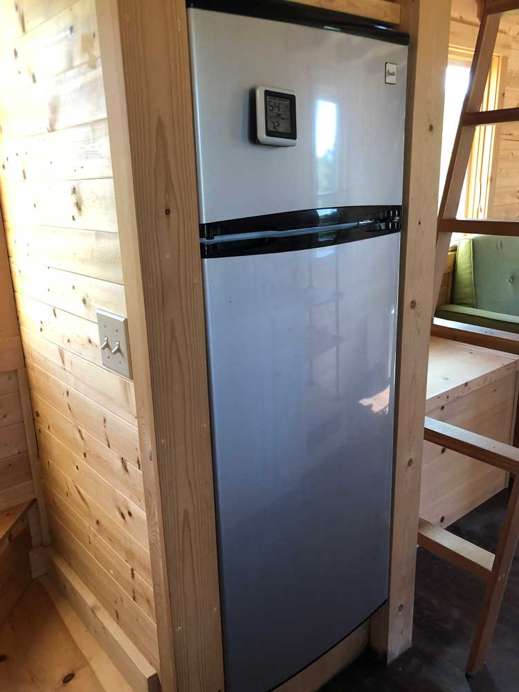 The fridge in the Contemporary Cottage custom tiny home