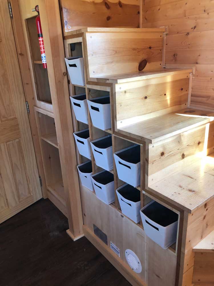 Stairs to loft with built in storage on the Contemporary Cottage custom tiny home