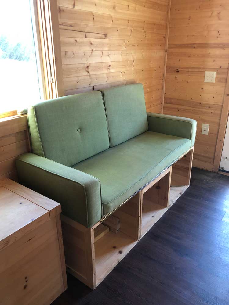 Couch with storage in the Contemporary Cottage custom tiny home