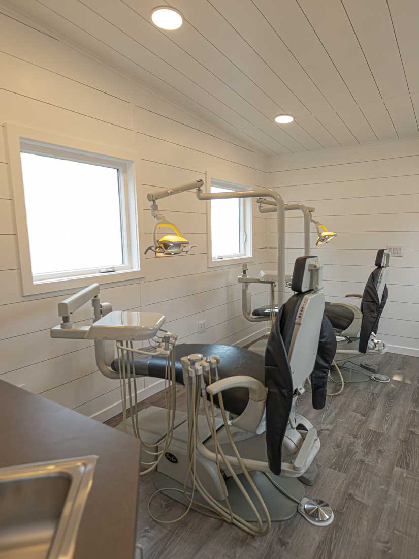 Gentle Dental mobile dentist office commerical tiny house showing interior with dentist chairs and equipment, windows